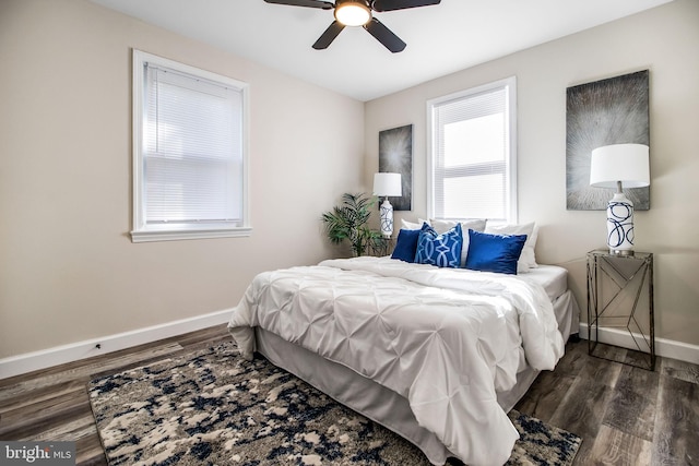 bedroom with ceiling fan and dark hardwood / wood-style floors