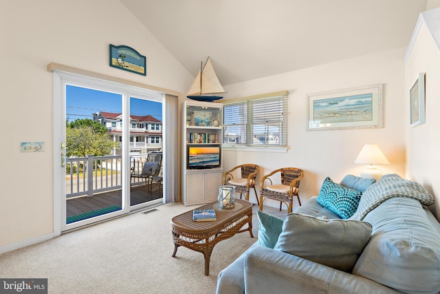 living room featuring carpet floors, high vaulted ceiling, and a wealth of natural light