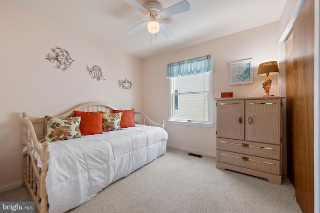 bedroom with ceiling fan and light colored carpet