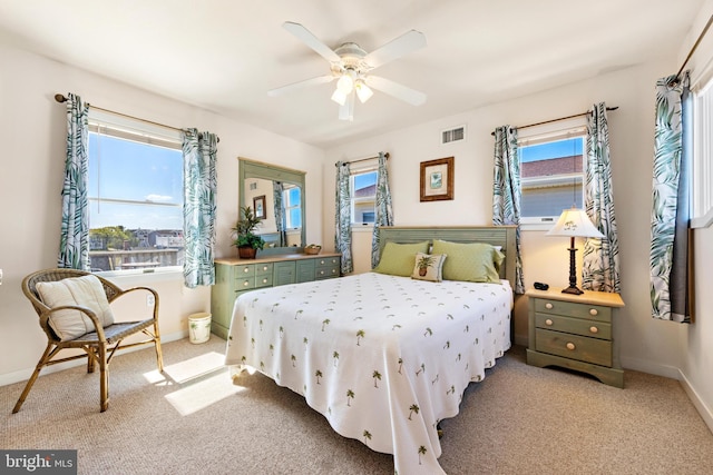 bedroom featuring ceiling fan and light carpet