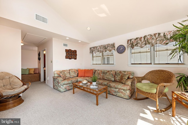 living room with vaulted ceiling and light colored carpet