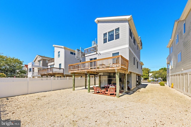 rear view of property featuring a deck