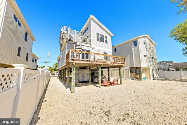 rear view of property featuring a deck