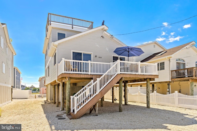 back of property with a wooden deck