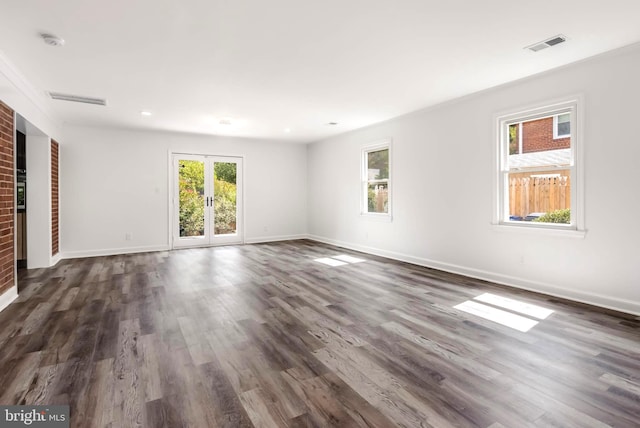 unfurnished living room featuring dark hardwood / wood-style flooring and french doors