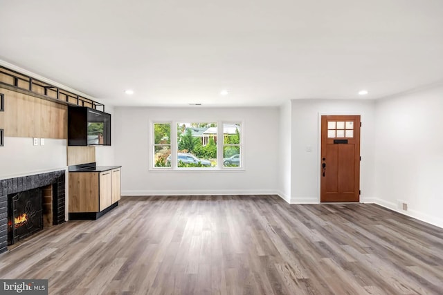 unfurnished living room with light hardwood / wood-style flooring