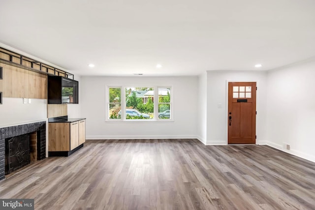 unfurnished living room featuring wood-type flooring