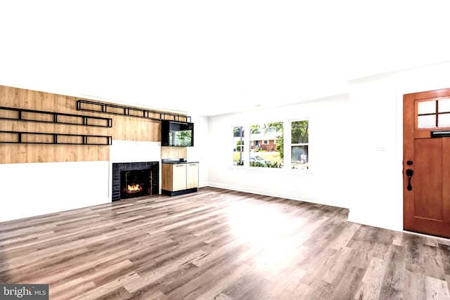 unfurnished living room featuring hardwood / wood-style flooring and a fireplace