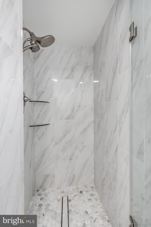 bathroom with a tile shower