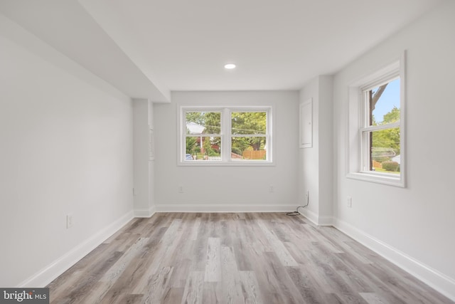 unfurnished room featuring light hardwood / wood-style flooring and plenty of natural light