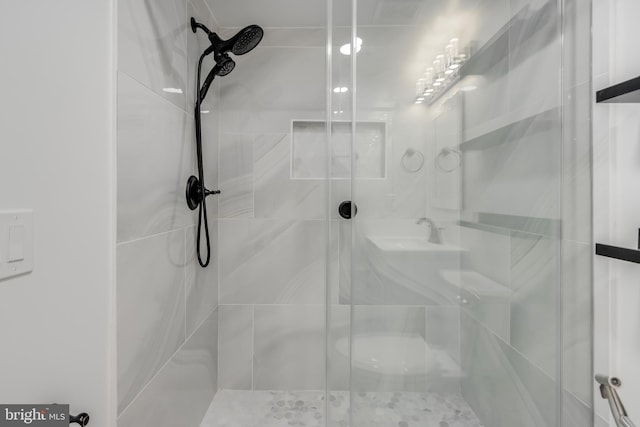 bathroom with a shower with shower door