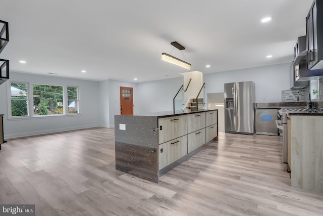 kitchen featuring light hardwood / wood-style flooring, appliances with stainless steel finishes, and a kitchen island