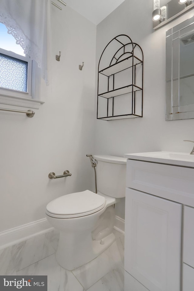 bathroom with vanity and toilet