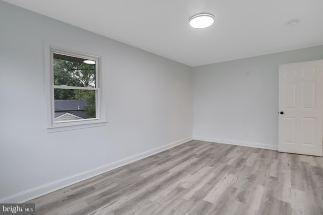 empty room with light hardwood / wood-style flooring