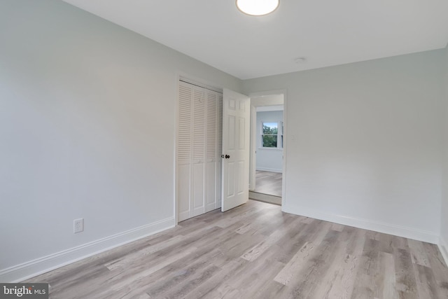 unfurnished room with light wood-type flooring