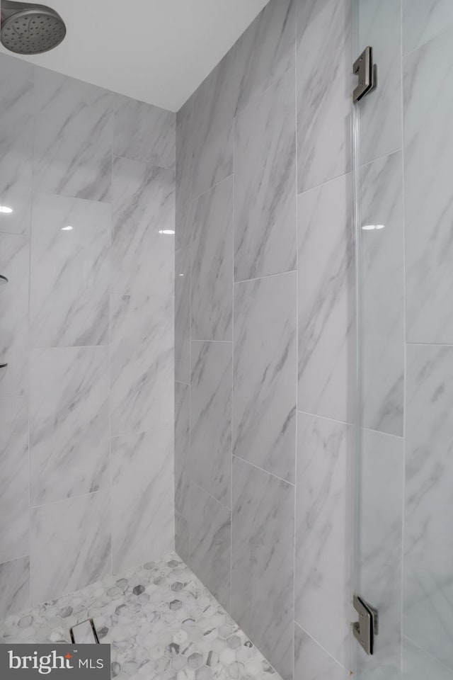 bathroom with a tile shower