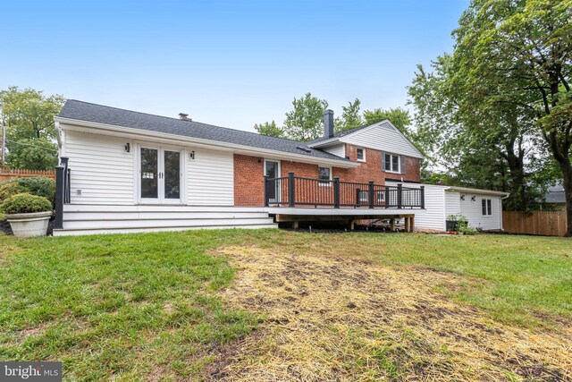 exterior space with a deck and a front lawn