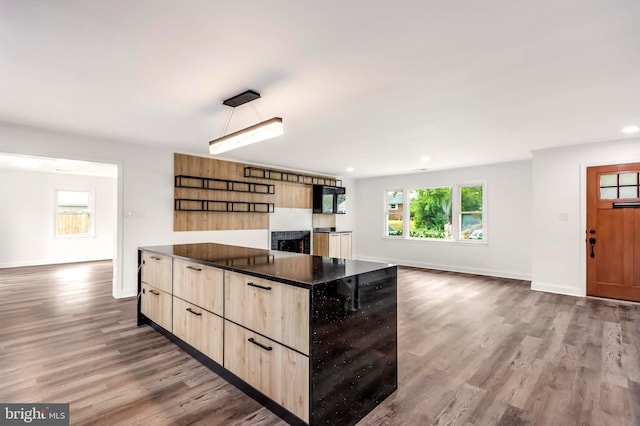 kitchen featuring wood-type flooring and light brown cabinets