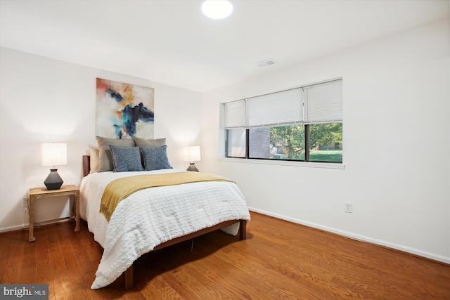 bedroom featuring dark hardwood / wood-style flooring