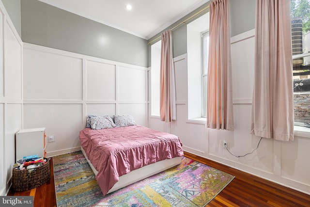 bedroom featuring ornamental molding and hardwood / wood-style floors