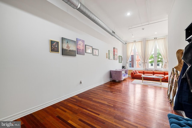 interior space with rail lighting and hardwood / wood-style floors