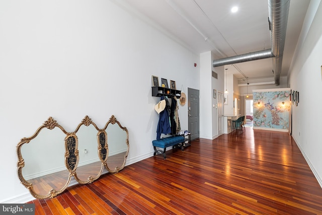 interior space featuring dark hardwood / wood-style flooring and a high ceiling