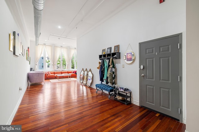 entrance foyer with track lighting and dark hardwood / wood-style floors