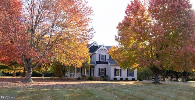 obstructed view of property with a front lawn