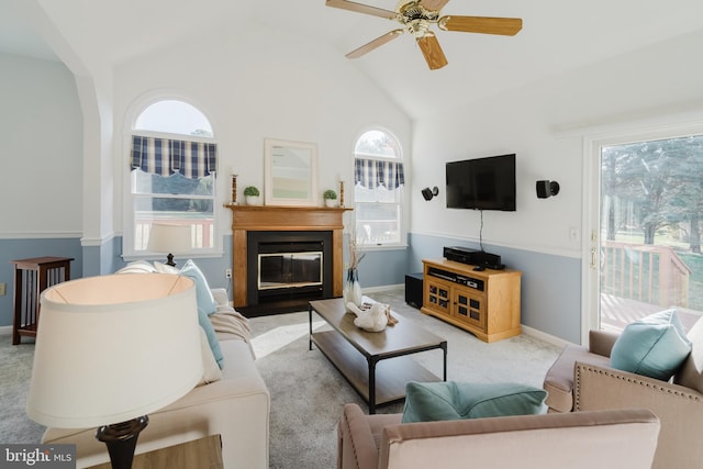 living room with ceiling fan, light carpet, and vaulted ceiling