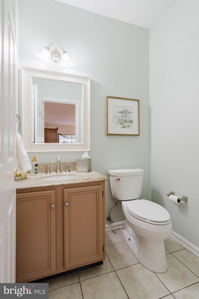 bathroom with tile patterned floors, vanity, and toilet