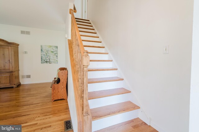 stairway featuring hardwood / wood-style floors