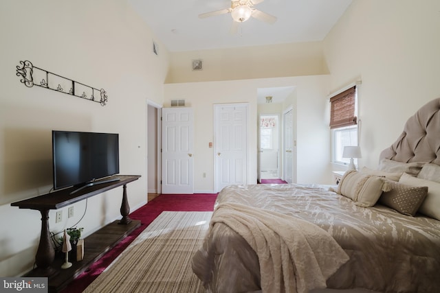 bedroom featuring dark hardwood / wood-style flooring, high vaulted ceiling, and ceiling fan