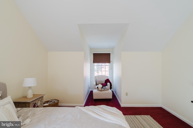 carpeted bedroom featuring lofted ceiling