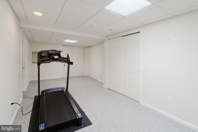 exercise area with carpet and a drop ceiling