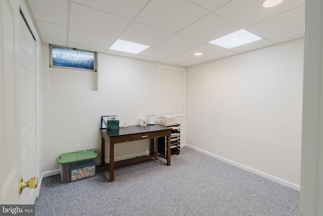 office space with a paneled ceiling and carpet floors