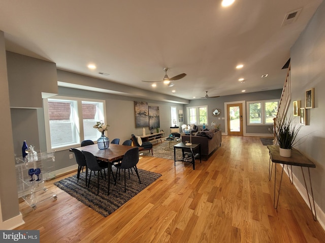 dining space with light hardwood / wood-style flooring and ceiling fan