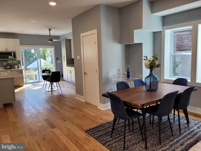 dining space featuring light hardwood / wood-style flooring and ceiling fan