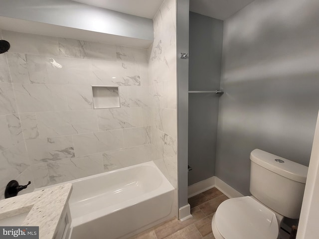 full bathroom with tiled shower / bath combo, vanity, and toilet