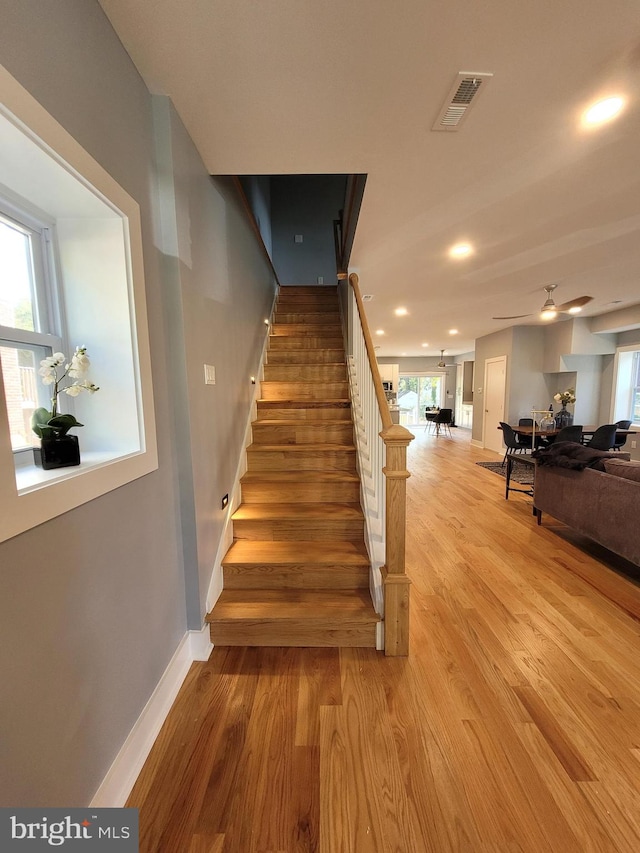 stairs featuring hardwood / wood-style flooring