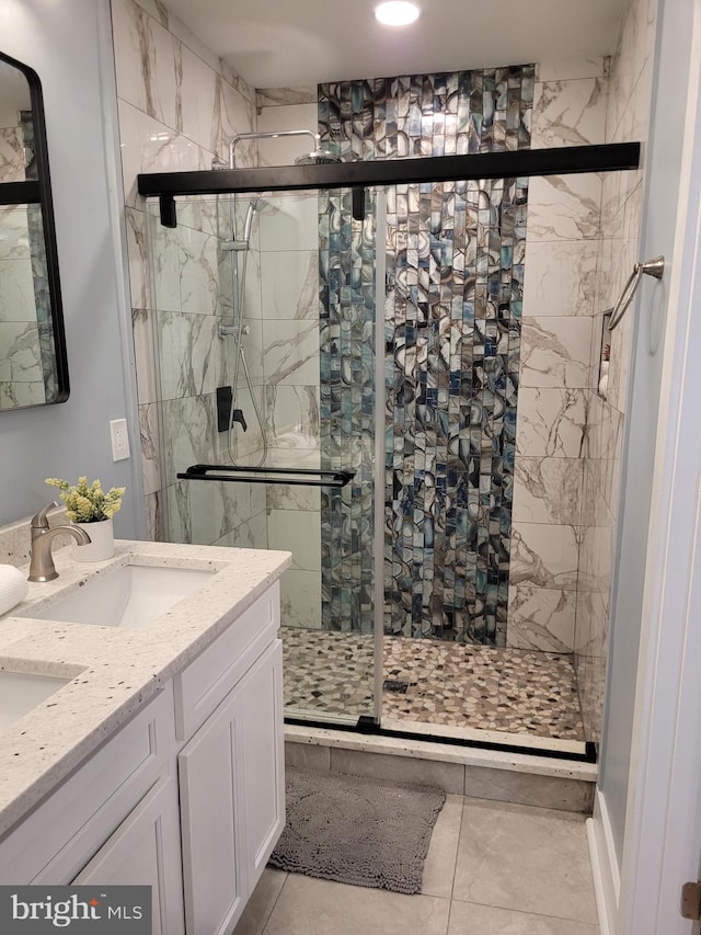 bathroom with tile patterned flooring, vanity, and a shower with shower door