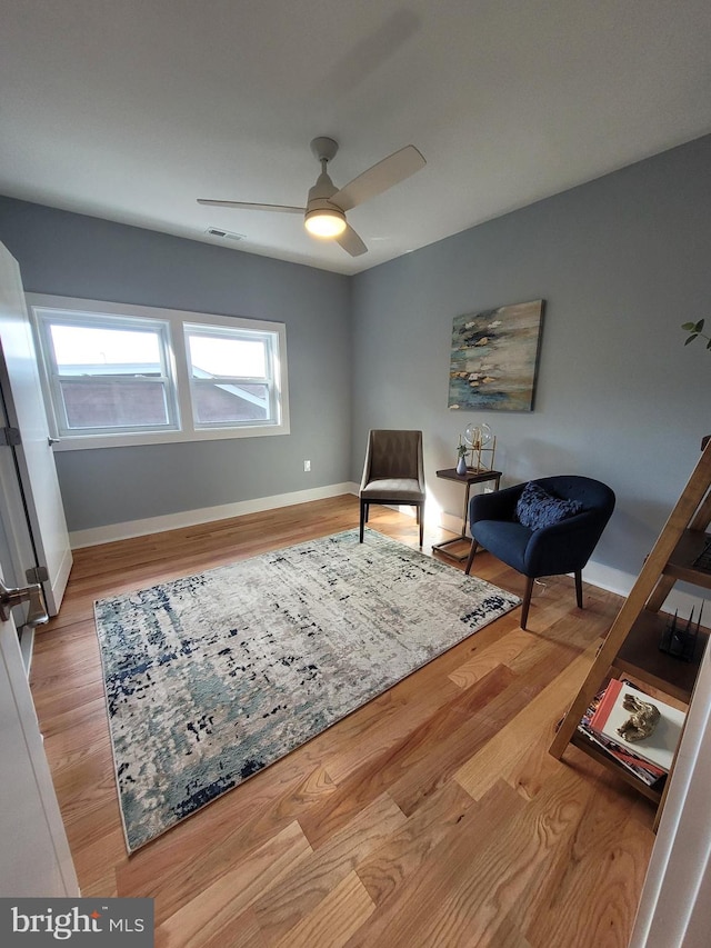 sitting room featuring light hardwood / wood-style flooring and ceiling fan