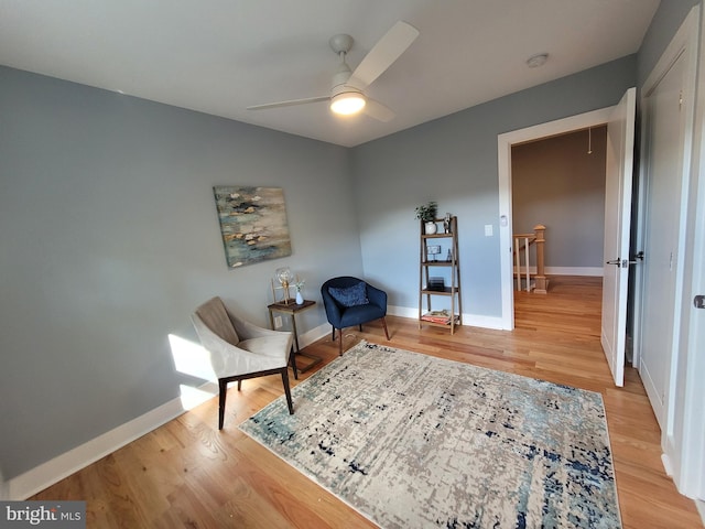 sitting room featuring ceiling fan and light hardwood / wood-style flooring