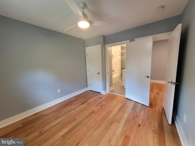 unfurnished bedroom with ensuite bath, light hardwood / wood-style floors, and ceiling fan