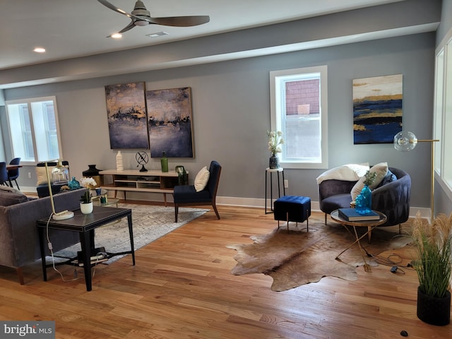 living room featuring light hardwood / wood-style floors, plenty of natural light, and ceiling fan