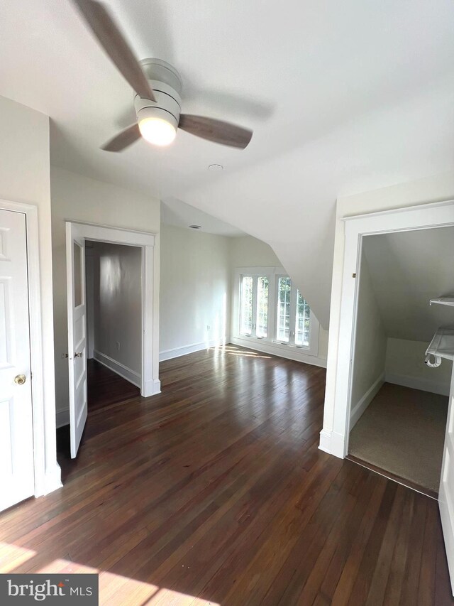 interior space featuring vaulted ceiling, dark hardwood / wood-style floors, and ceiling fan