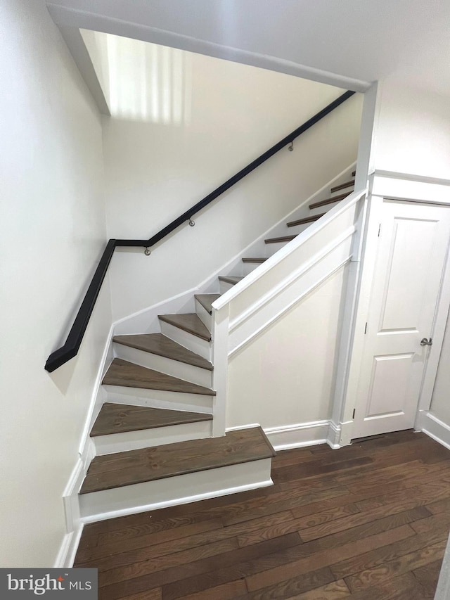 stairway with hardwood / wood-style floors