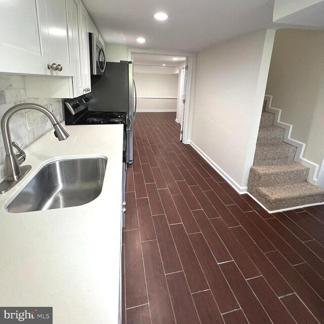 kitchen featuring dark hardwood / wood-style floors, sink, and white cabinets