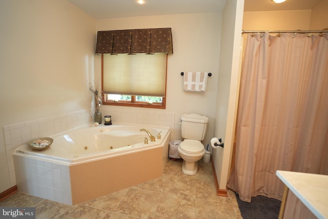 bathroom featuring tile patterned floors, a relaxing tiled tub, vanity, and toilet