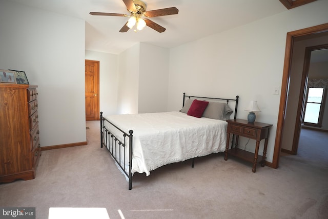 bedroom with ceiling fan and light carpet