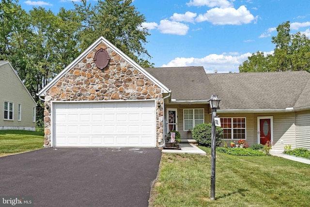 view of front of property with a garage and a front yard